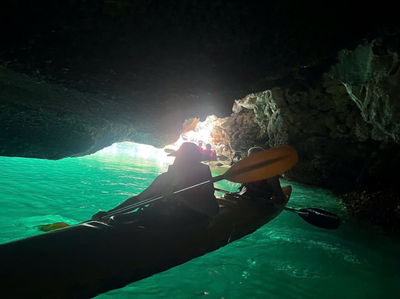 Kayakers near a floating village in Lan Ha Bay